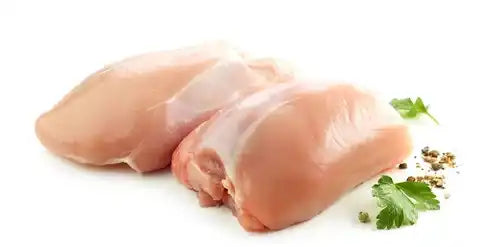 Certified organic boneless chicken legs, skin on, close-up.