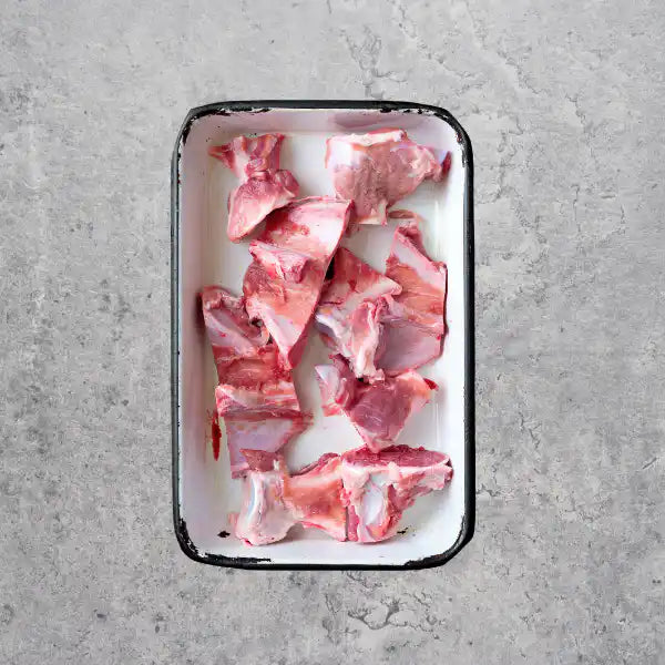 Australian free range pork bones, cut, on a light background.