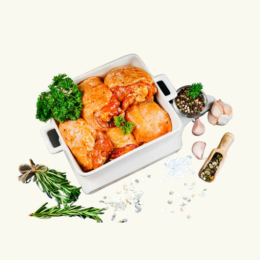 Marinated certified organic boneless chicken legs on a light background.