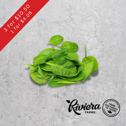 Baby spinach salad leaves, Riviera Farms, on a light background.