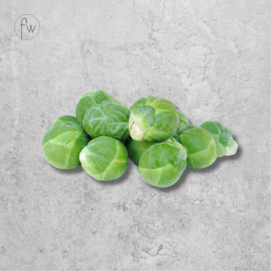 A small pile of fresh green Brussels sprouts centered on a light gray textured stone-like background. A small circular 'fw' logo appears in the upper left corner.