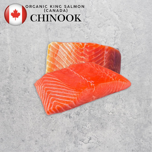 Two pieces of organic Chinook salmon on a gray surface with a Canadian flag label.