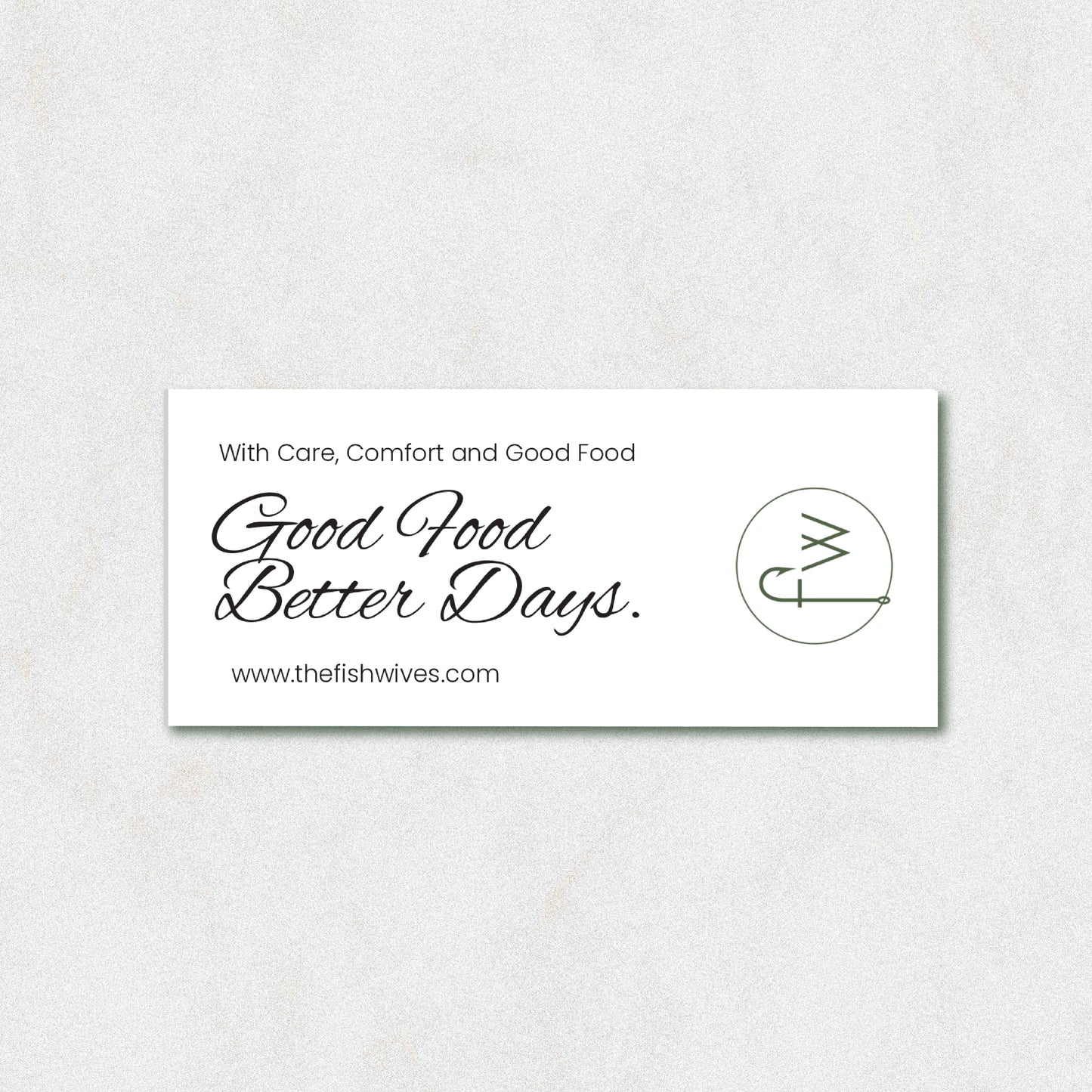 A white rectangular business card with black text reading 'With Care, Comfort and Good Food Good Food Better Days.' and the website www.