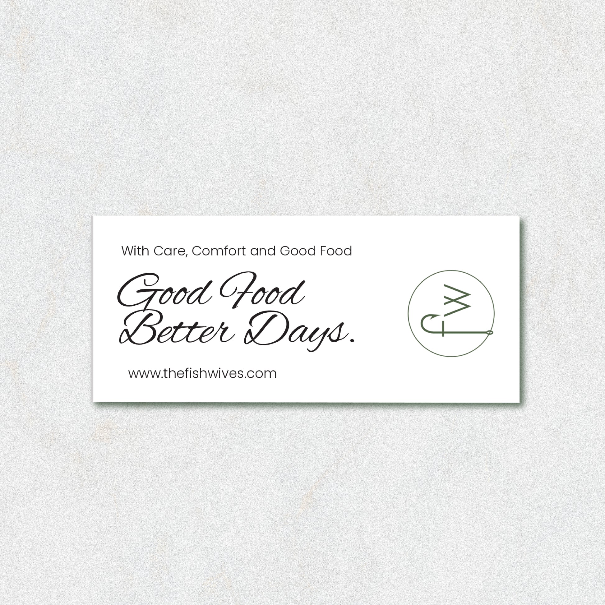 A white rectangular business card with black text reading 'With Care, Comfort and Good Food Good Food Better Days.' and the website www.