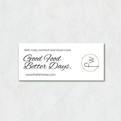 A white rectangular business card with black text reading 'With Care, Comfort and Good Food Good Food Better Days.' and the website www.