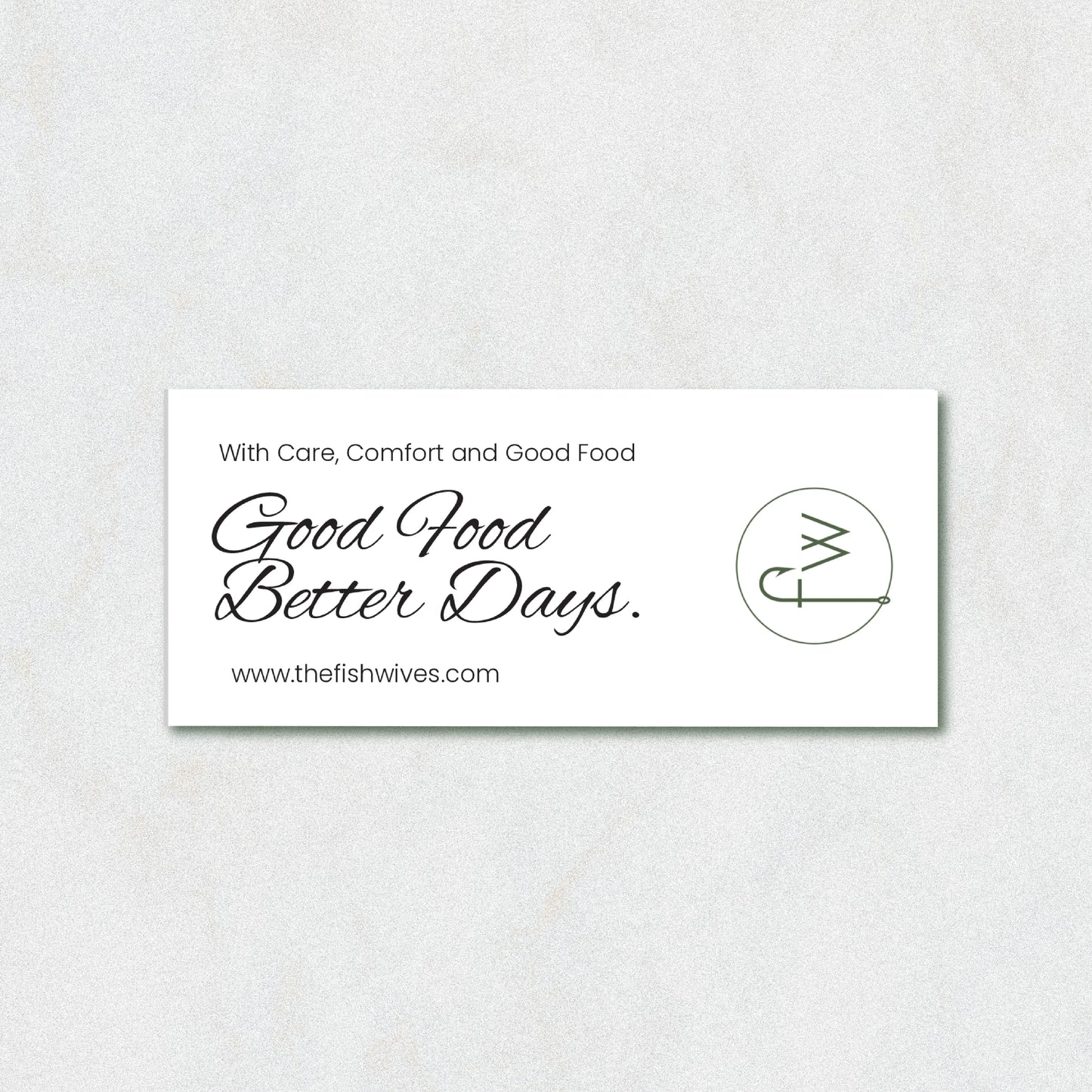 A white rectangular business card with black text reading 'With Care, Comfort and Good Food Good Food Better Days.' and the website www.
