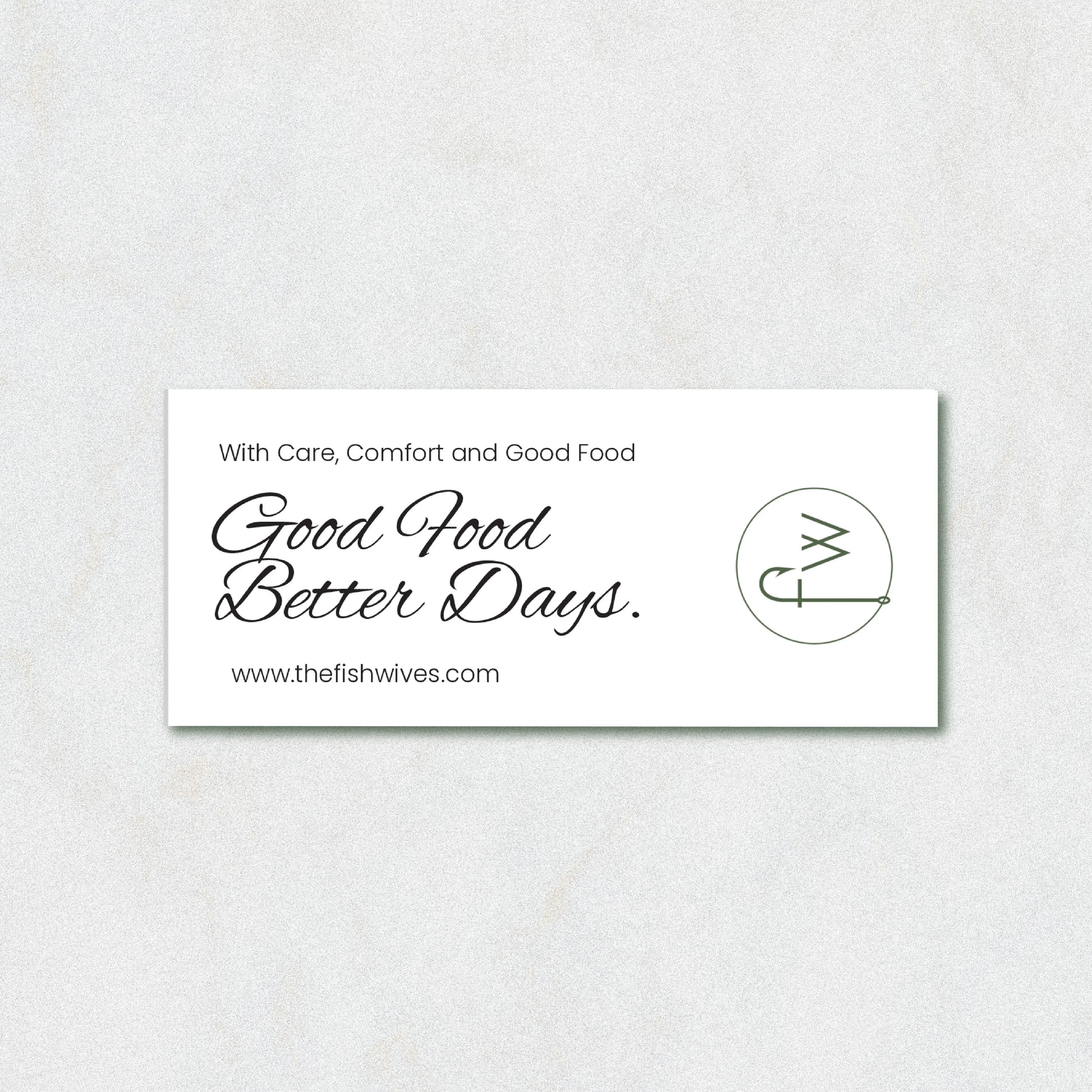A white rectangular business card with black text reading 'With Care, Comfort and Good Food Good Food Better Days.' and the website www.