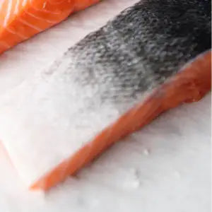 New Zealand King Salmon fillet, frozen, on a light background.