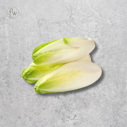Two pale green and off-white lettuce leaves arranged on a textured light gray surface, with a small circular 'fw' logo in the upper left corner.