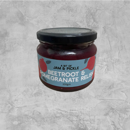 A jar of Jam & Pickle beetroot and pomegranate relish on a grey background.
