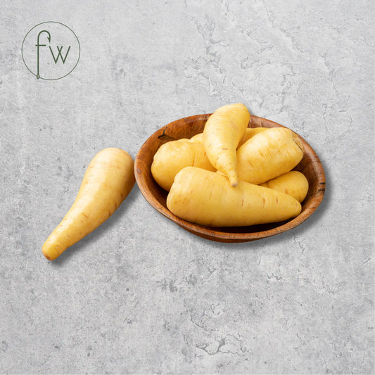 Wooden bowl with yellow root vegetables Parsnip on a gray surface, featuring the brand 'fw'.