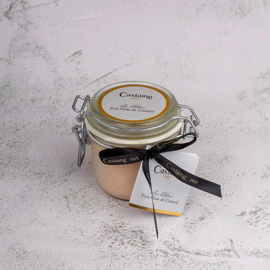 Jar of Castaing foie gras on a textured white surface