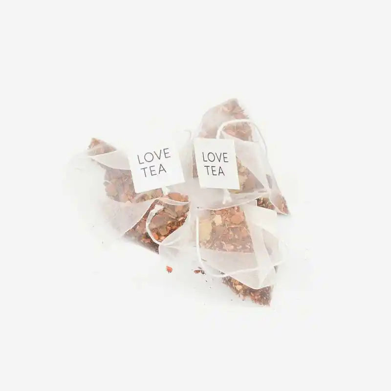 Loose caffeine free chai pyramid tea bags on a white background.
