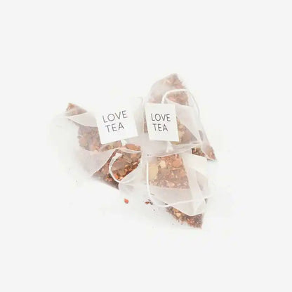 Loose caffeine free chai pyramid tea bags on a white background.