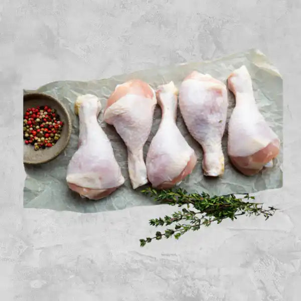 Certified organic chicken drumsticks on a light background.