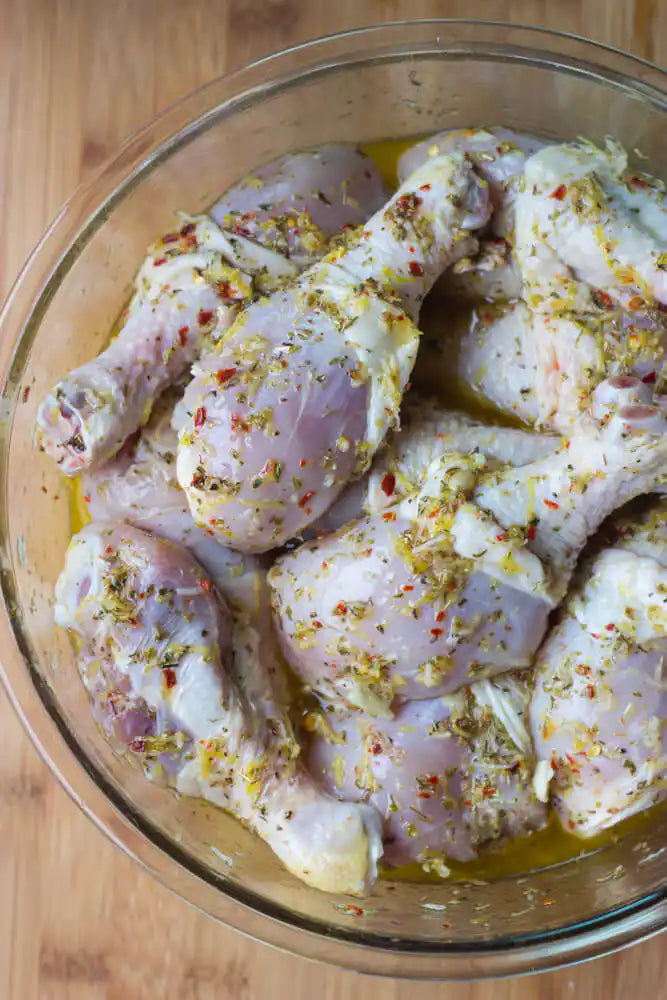 Greek yoghurt and lemon marinated chicken drumsticks in packaging.