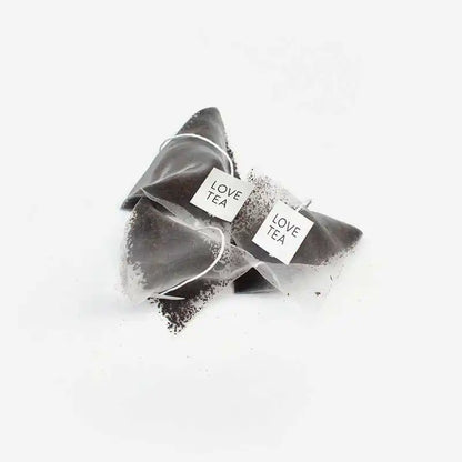 English Breakfast Tea pyramid bags on a white background.