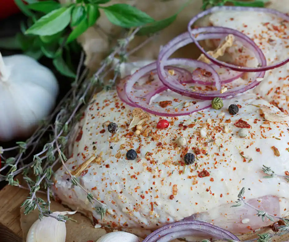 Marinated certified organic chicken thigh on a plate.