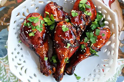 Marinated certified organic chicken drumsticks close-up.